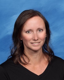 A person with brown hair wearing a black shirtDescription automatically generated